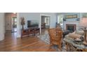 Cozy living room boasts hardwood floors, fireplace, comfortable seating, and seamless flow to other rooms at 709 Myrtle Dr, Rock Hill, SC 29730