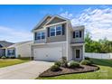 Inviting two-story home with a two-car garage, beautifully landscaped front yard and appealing curb appeal under a sunny sky at 7113 Amberly Hills Rd, Charlotte, NC 28215