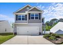 Welcoming exterior of a two-story house featuring a two-car garage, neat landscaping, and classic architectural details at 7113 Amberly Hills Rd, Charlotte, NC 28215