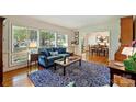 Bright living room with large windows, hardwood floors, and an elegant rug, perfect for entertaining and relaxation at 751 Lansdowne Rd, Charlotte, NC 28270