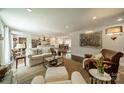 Open-concept living room with dining area and kitchen, perfect for entertaining at 8330 Fallsdale Dr, Charlotte, NC 28214