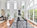 Elegant dining room with soaring windows, modern lighting, and stylish furnishings perfect for entertaining at 8921 Magnolia Heights Ct, Charlotte, NC 28270