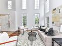 Bright living room with soaring ceilings, large windows, and modern furnishings, creating a welcoming atmosphere at 8921 Magnolia Heights Ct, Charlotte, NC 28270