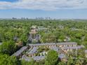 An aerial view showing the community, pool, and greenery with the city skyline visible in the distance at 984 Park Slope Dr, Charlotte, NC 28209