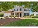 Two-story home featuring a brick and siding exterior, complemented by a well-manicured front yard and a two-car garage at 105 Runningdeer Dr, Mooresville, NC 28117