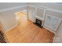 Living room with fireplace, hardwood floors, and an open layout to other living spaces at 108 Bare Foot Ln, Mooresville, NC 28117