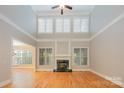 Bright living room features hardwood floors, fireplace, and high ceilings with abundant natural light at 108 Bare Foot Ln, Mooresville, NC 28117