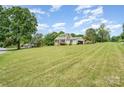 Expansive lawn showcasing a charming home with a rear deck and attached garage at 109 Terrace Pl, Lincolnton, NC 28092