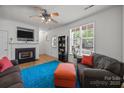 Bright living room with a fireplace and large window with natural light at 11139 Dundarrach Ln, Charlotte, NC 28277