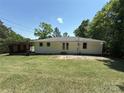 Spacious backyard featuring a well-maintained lawn and partial privacy, perfect for outdoor entertaining at 12719 Cottonville Rd, Norwood, NC 28128