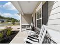 Inviting front porch with rocking chairs to create a warm welcome to your home at 132 Moores Branch Rd, Mount Holly, NC 28120