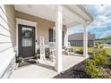 Inviting front porch with rocking chairs, a welcome mat, and thoughtful decor to create a warm entrance at 132 Moores Branch Rd, Mount Holly, NC 28120