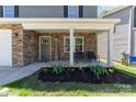 Inviting front porch with stacked stone, rocking chairs, and a 'Welcome' sign for a cozy touch at 1336 26Th Ne Ave, Hickory, NC 28601