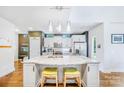 Bright kitchen featuring white cabinets, granite countertops, pendant lighting, and stainless steel appliances at 1421 Lyon Ct, Charlotte, NC 28205