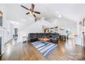 Open living room with vaulted ceiling, wood floors, and a comfortable leather sectional sofa at 1421 Lyon Ct, Charlotte, NC 28205