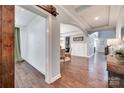 Bright foyer with hardwood floors, decorative archways, and a glimpse into other living spaces at 1446 Cilantro Ct, Tega Cay, SC 29708