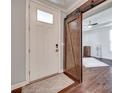 Welcoming foyer with hardwood floors, a white front door, and a sliding barn door at 1446 Cilantro Ct, Fort Mill, SC 29708