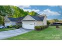 Low-angle view of a well-maintained house with a wide driveway and lush green lawn at 1618 33Rd Ne Ave # 1, Hickory, NC 28601