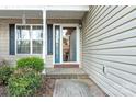 Inviting entryway with a blue front door and brick accents, framed by a landscaped garden at 1618 33Rd Ne Ave # 1, Hickory, NC 28601