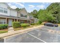 Attractive townhome with brick accents, manicured shrubs, and assigned parking spaces at 1720 Forest Side Ln, Charlotte, NC 28213