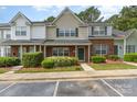 Charming townhome features a brick facade, lush landscaping, and convenient parking at 1720 Forest Side Ln, Charlotte, NC 28213
