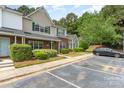 Well-maintained townhome with brick accents, manicured shrubs, and assigned parking spaces at 1720 Forest Side Ln, Charlotte, NC 28213