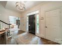 Inviting foyer with hardwood floors, elegant chandelier, and a glimpse of the living spaces, promising a warm welcome at 242 Beckham Ct, Charlotte, NC 28211