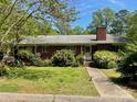 Charming single-story brick home with a well-maintained front yard and lush landscaping at 3100 Ventosa Dr, Charlotte, NC 28205
