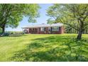 Lovely brick home featuring a large front lawn and mature trees for shade at 3340 Wrenwood Dr, Newton, NC 28658