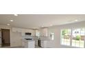 Bright kitchen features modern lighting, granite countertops, stainless appliances, and modern white cabinetry at 406 W Marion St, Kershaw, SC 29067