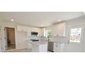 Well-lit kitchen featuring granite countertops, stainless steel appliances and modern white cabinets at 406 W Marion St, Kershaw, SC 29067