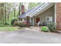 Beautiful front entrance with covered walkway, brick accents, and lush landscaping at 512 Saint Cloud Dr, Statesville, NC 28625