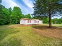 Single story home featuring a lawn and mature shade tree at 5318 Austin Rd, Monroe, NC 28112