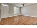 Inviting living room featuring hardwood floors, a ceiling fan, and a bright window at 542 Goldstaff Ln, Charlotte, NC 28273