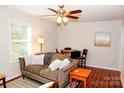 Comfortable living room features wood floors, ceiling fan, and sofa with decorative pillows at 602 Childs St, Lincolnton, NC 28092