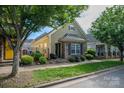 Charming home featuring a combination of stone and shingle siding, complemented by manicured landscaping at 6029 Bountiful St, Belmont, NC 28012