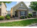 Charming home featuring a combination of stone and shingle siding, complemented by manicured landscaping at 6029 Bountiful St, Belmont, NC 28012