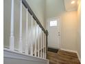 Inviting entryway featuring a staircase with a stylish railing and a front door with glass accents at 604 Tudor Park Way, Charlotte, NC 28211