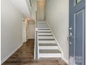 Welcoming entryway with hardwood floors, leading to a staircase and featuring an elegant front door at 604 Tudor Park Way, Charlotte, NC 28211