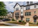 Charming townhomes featuring brick and siding accents with inviting curb appeal on a sunny day at 604 Tudor Park Way, Charlotte, NC 28211