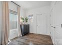 Bright entryway featuring hardwood floors, a stylish console table, and a white door with silver hardware at 637 Scotch Meadows Loop, Monroe, NC 28110