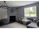 Comfortable living room with a modern fireplace, stylish furnishings, and plenty of natural light from a large window at 6518 Blackwood Ln, Waxhaw, NC 28173