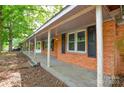 Inviting covered porch featuring classic brick and neutral trim at 7224 Kuck Rd, Mint Hill, NC 28227