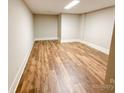 Spacious finished basement area featuring durable wood flooring and recessed lighting, perfect for flexible living space at 724 Ideal Way, Charlotte, NC 28203