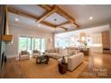 Bright living room with wood beam ceiling, hardwood floors, comfortable seating, and access to a deck at 724 Ideal Way, Charlotte, NC 28203