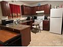 Functional kitchen with stainless steel sink, white appliances and ample counter space at 7539 Holly Grove Ct, Charlotte, NC 28227