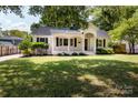 Well-manicured front yard of a white brick house with a covered porch at 754 Wriston Pl, Charlotte, NC 28209