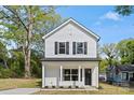 Charming two-story home with white siding, black shutters, and a welcoming front porch at 808 Carolyn Ave, Kannapolis, NC 28083