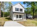 Charming two-story home with white siding, black shutters, and a welcoming front porch at 808 Carolyn Ave, Kannapolis, NC 28083