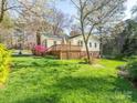 The backyard features a spacious wooden deck, perfect for outdoor entertaining at 8801 Chinaberry Ln, Concord, NC 28027